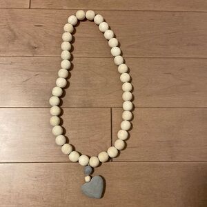 Wooden and concrete prayer beads. Jillian Harris collaboration with The Cross